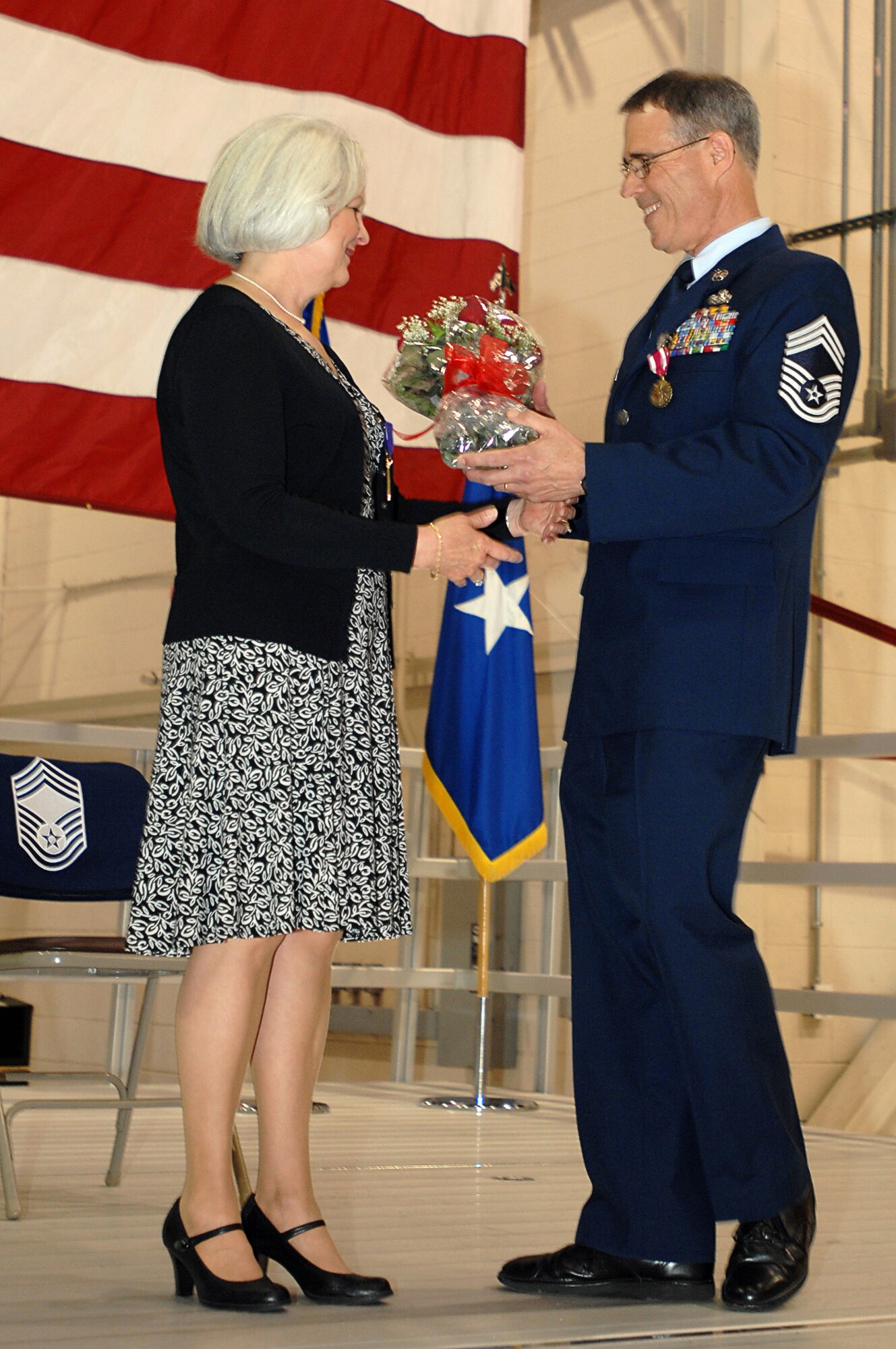 GRISSOM AIR RESERVE BASE, Ind. -- Chief Master Sgt. David Sward, 434th Maintenance Squadron superintendent, gives his wife, Karen, a bouquet of roses in appreciation for her support of his military career during the chief's retirement ceremony here April 10. Chief Sward began his military career in 1973 as an Airman basic and progressed to the highest enlisted rank of chief master sergeant. (U.S. Air Force photo/Tech. Sgt. Mark R. W. Orders-Woempner)