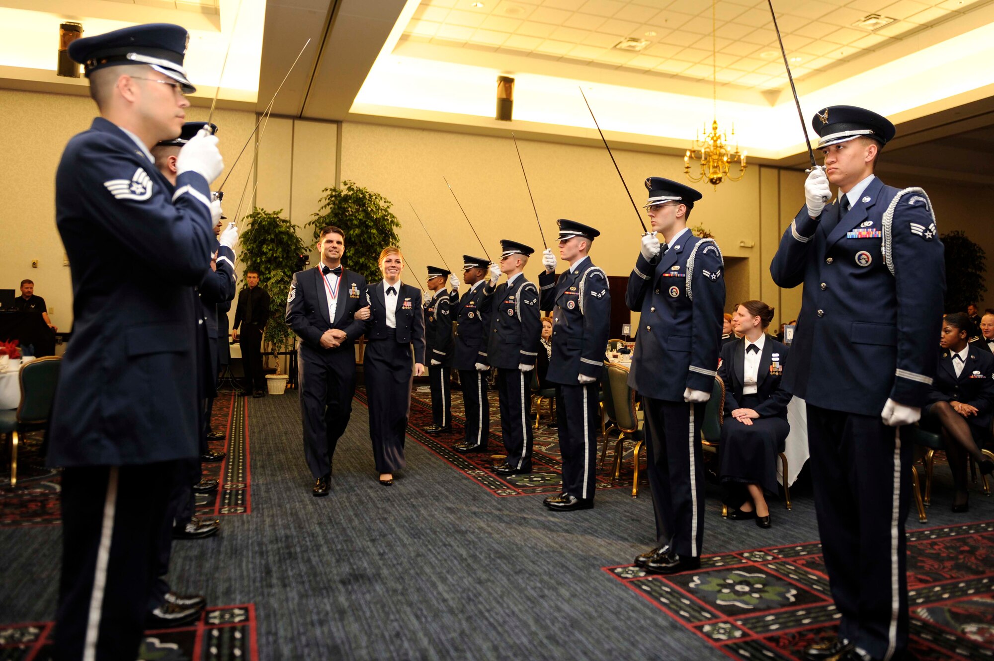 Master Sgt. Joseph Kazimer, 421st Combat Training Squadron, is escorted through an Air Force Honor Guard formation by his daughter, Airman 1st Class Nicole Kazimer from the 39th Airlift Squadron at Dyess Air Force Base, Texas, after winning Air Mobility Command’s Senior NCO of the year award April 8 at Scott AFB, Ill.  Sergeant Kazimer is now competing at the Air Force level for the opportunity to be named one of the services 12 Outstanding Airmen of the Year.  (U.S. Air Force photo by Senior Airman Wesley Farnsworth).