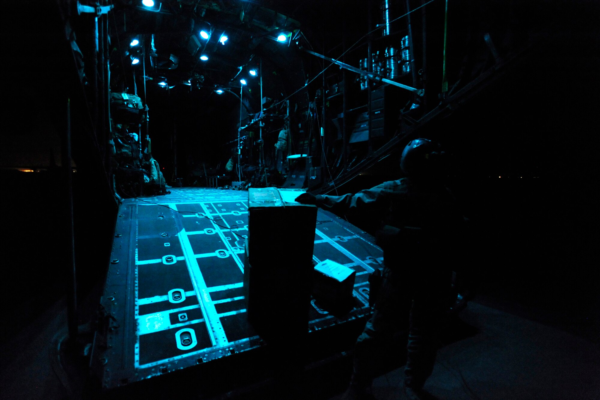 Senior Airman Michael Schoettlin, an HC-130P “Combat King” Hercules loadmaster deployed to the 79th Expeditionary Rescue Squadron, waits to distribute medical supplies, April 10, 2010, in Herat, Afghanistan. HC-130s are deployed to Afghanistan again for the first time in five years. (U.S. Air Force photo/Staff Sgt. Manuel J. Martinez/released)