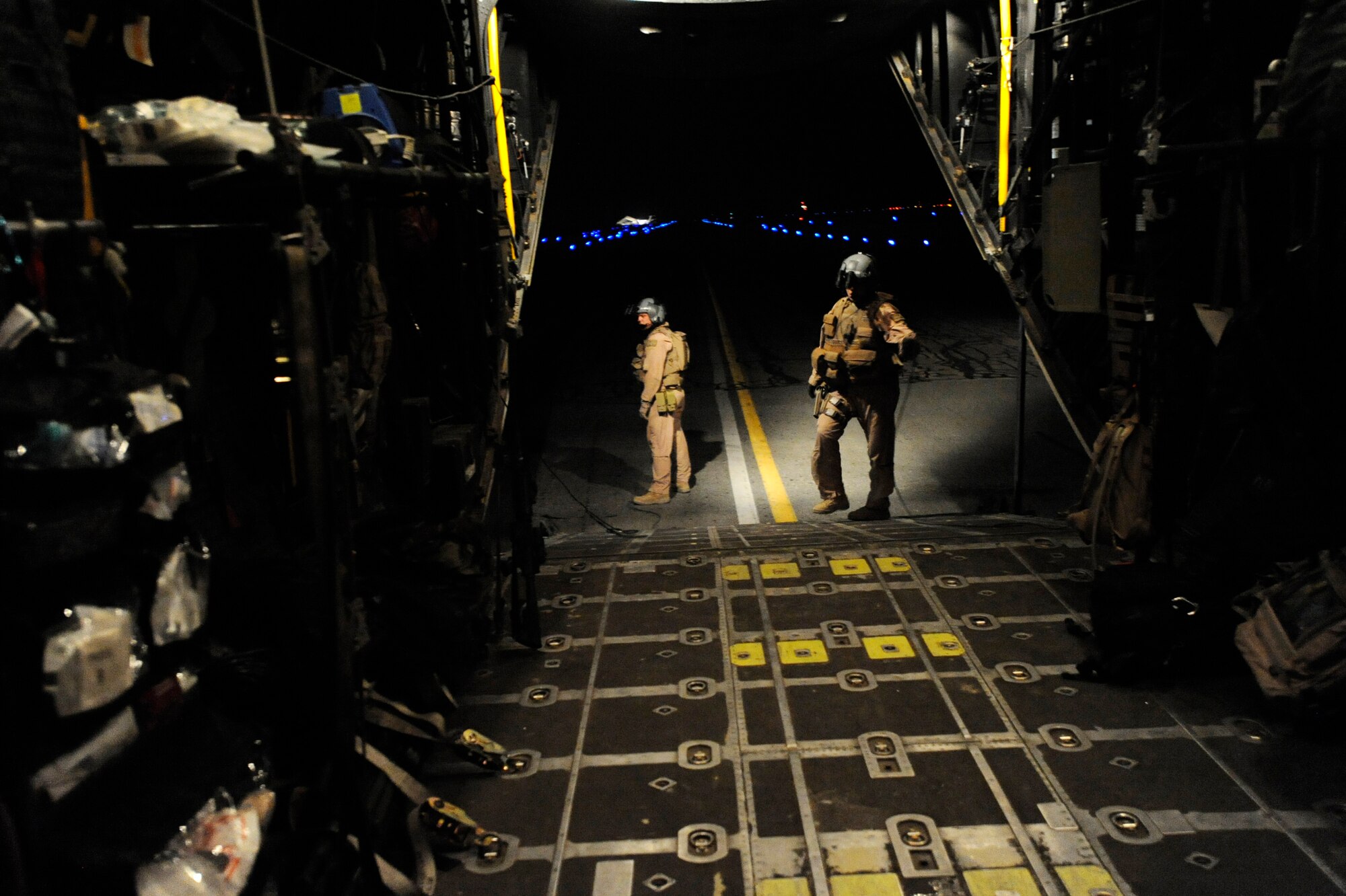 Senior Airman Michael Schoettlin, left, and Staff Sgt. Mary Sierra, both HC-130P “Combat King” Hercules loadmasters deployed to the 79th Expeditionary Rescue Squadron, wait for medical supplies to be delivered to the aircraft, April 10, 2010, at Kandahar Airfield, Afghanistan. (U.S. Air Force photo/Staff Sgt. Manuel J. Martinez/released)