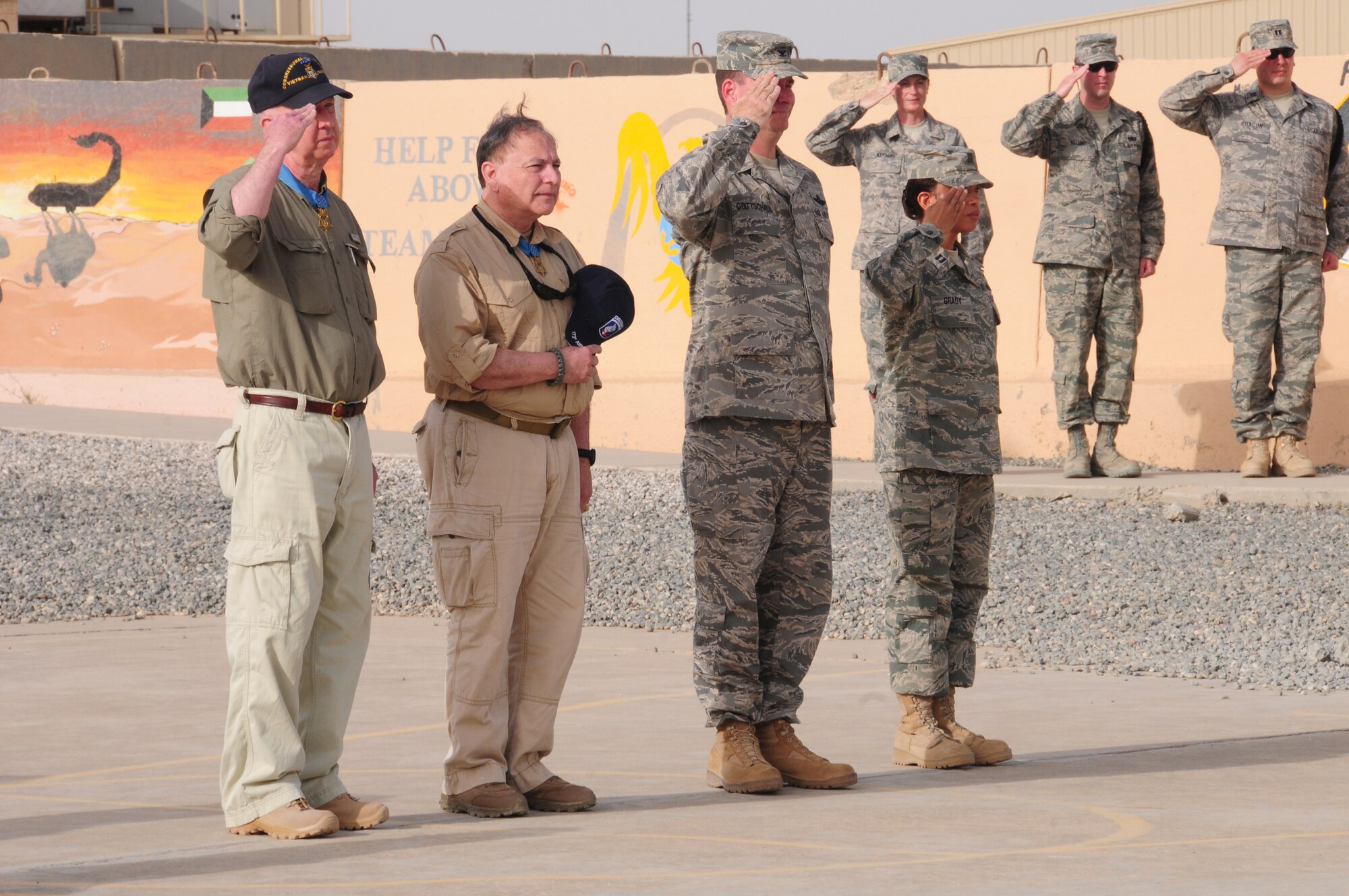 From left, Don Jenkins, retired U.S. Army Lt. Col. Alfred Rascon, U.S. Air Force Col. Gary Gottschall and Capt. Sheila Grady pay respect to the U.S. flag during a retreat ceremony April 10, 2010 at an air base in Southwest Asia. Mr. Jenkins and Colonel Rascon, both Vietnam era Medal of Honor recipients, shared their stories with Airmen as part of a tour visiting troops at various bases throughout the U.S. Central Command area of responsibility. Colonel Gottschall is the 386th Air Expeditionary Wing vice commander and Captain Grady is the 386th AEW protocol chief. (U.S. Air Force photo by Staff Sgt. Lakisha A. Croley/Released)