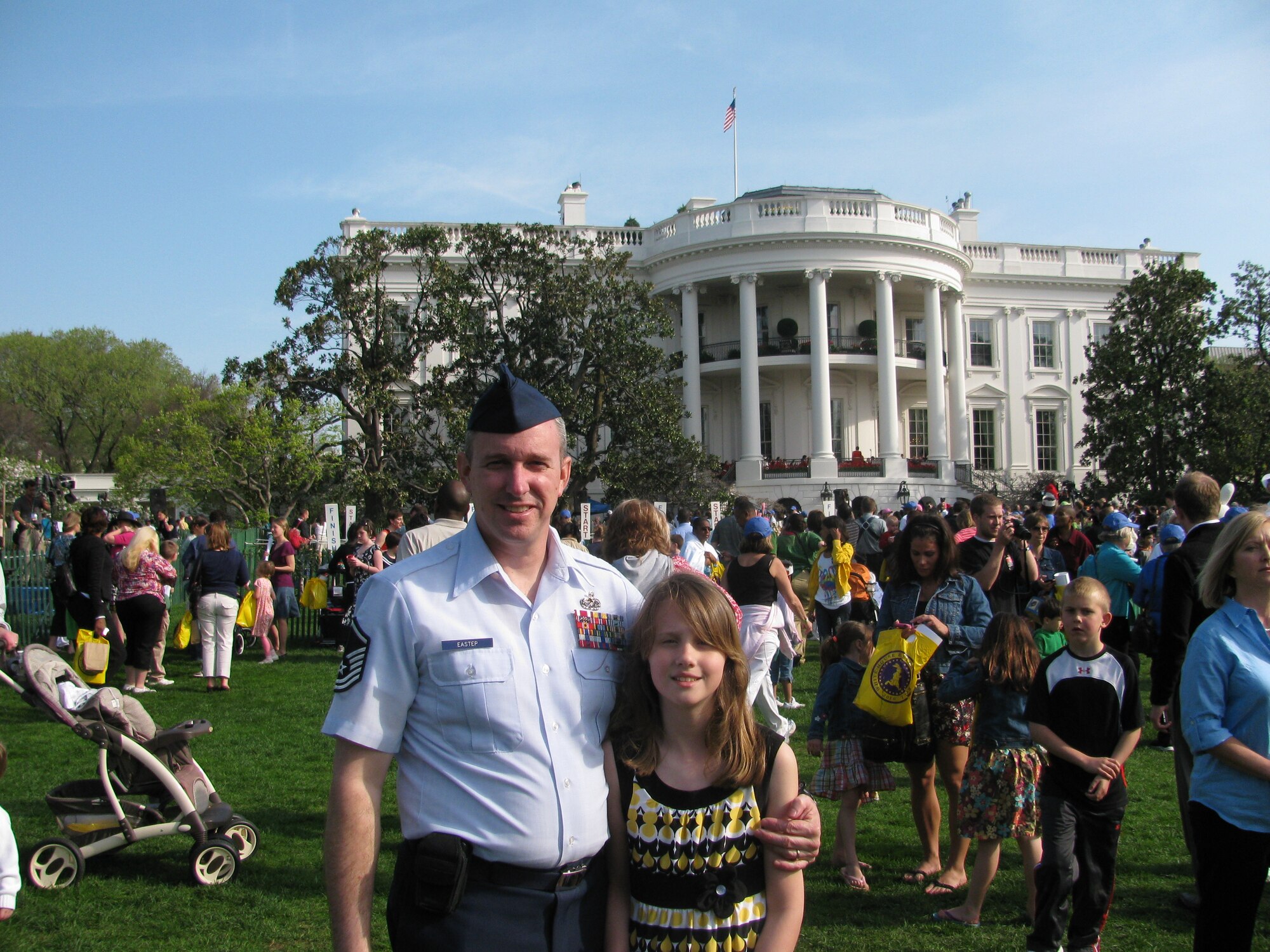 Master Sgt. Jeff Eastep, AMC Testing and Evaluation Squadron, stationed at Joint Base McGuire-Dix-Lakehurst, poses with daughter Alexa, 10, in front of the White House April 5. Eastep was one of 50 JB MDL members to participate in the annual White House Easter Egg Roll. Every child received a wooden egg signed by the President and First Lady as a keepsake. (Courtesy photo)