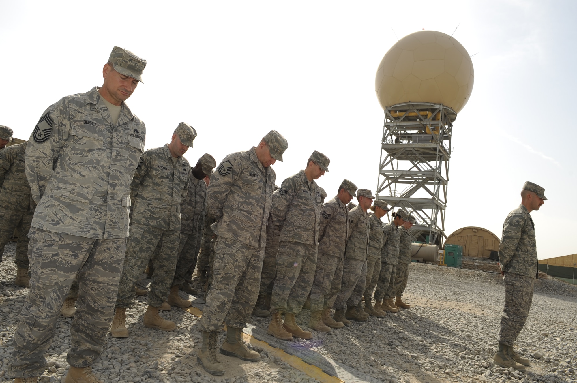 Members from the 73rd Expeditionary Air Control Squadron, Kandahar Airfield, take a moment of silence during a memorial ceremony for Airman 1st Class Antoine J. Holt.  Airman Holt served in Operation Iraqi Freedom at Balad Air Base, Iraq where he was fatally wounded on April 10, 2004 from a mortar attack that landed in his tent.  Many of the deployed members at the 73rd EACS are assigned to the 603rd ACS, Aviano Air Base, Italy, where Airman Holt was assigned prior to his deployment. Airman Holt was the only squadron member in the history of the unit to be killed in action while serving in a combat zone.  (U.S. Air Force photo by Senior Airman Nancy Hooks/Released)
