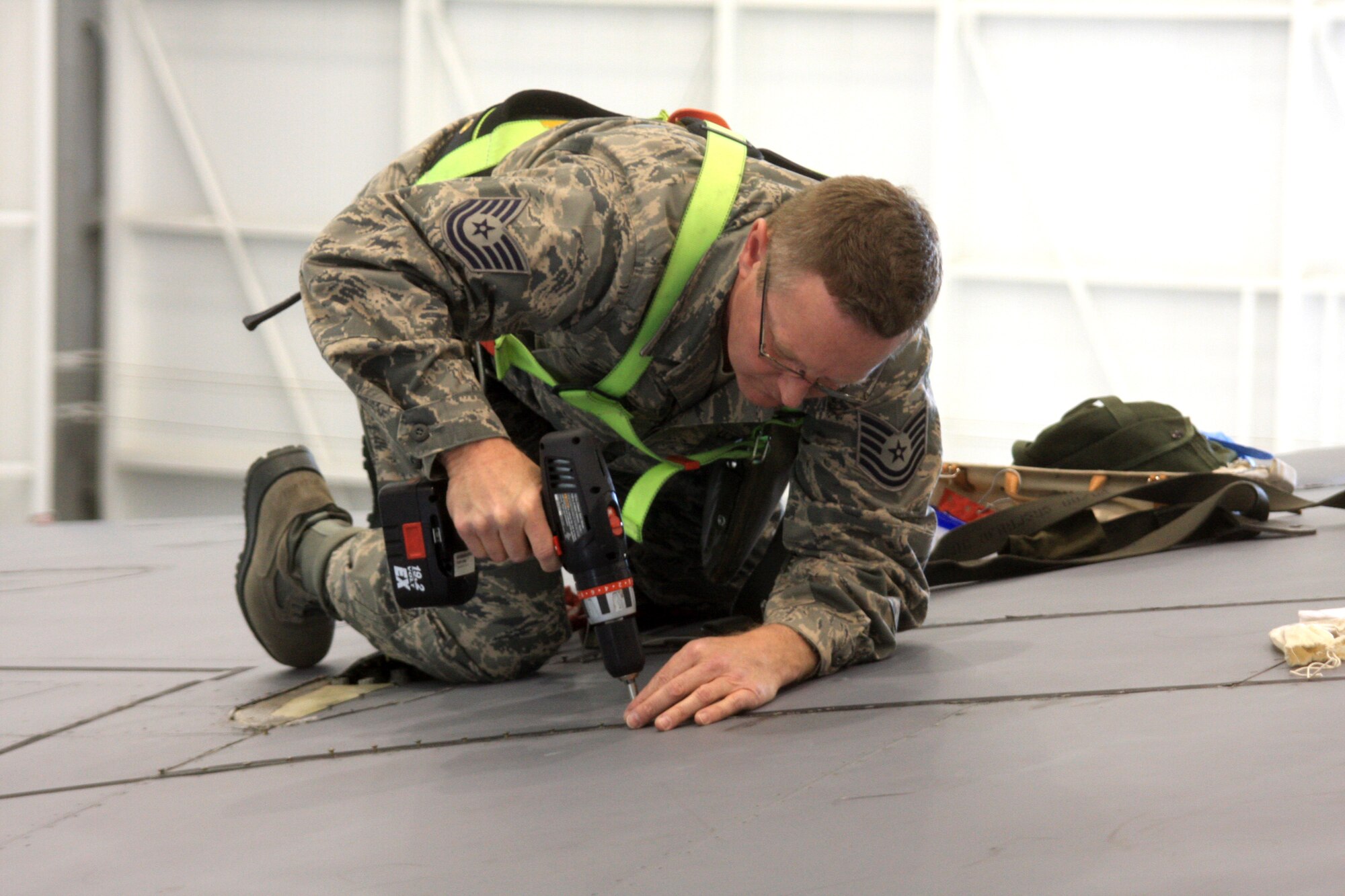WRIGHT-PATTERSON AIR FORCE BASE, Ohio – Tech. Sgt. Samuel Tanner, 445th Maintenance Squadron, reinstalls a panel on the wing of a C-5 Galaxy during an isochronal Inspection March 28.  During ISO inspections, aircraft maintainers look for and repair problems in every system, from nose to tail and wingtip to wingtip.  (U.S. Air Force photo/Senior Airman Mikhail Berlin)