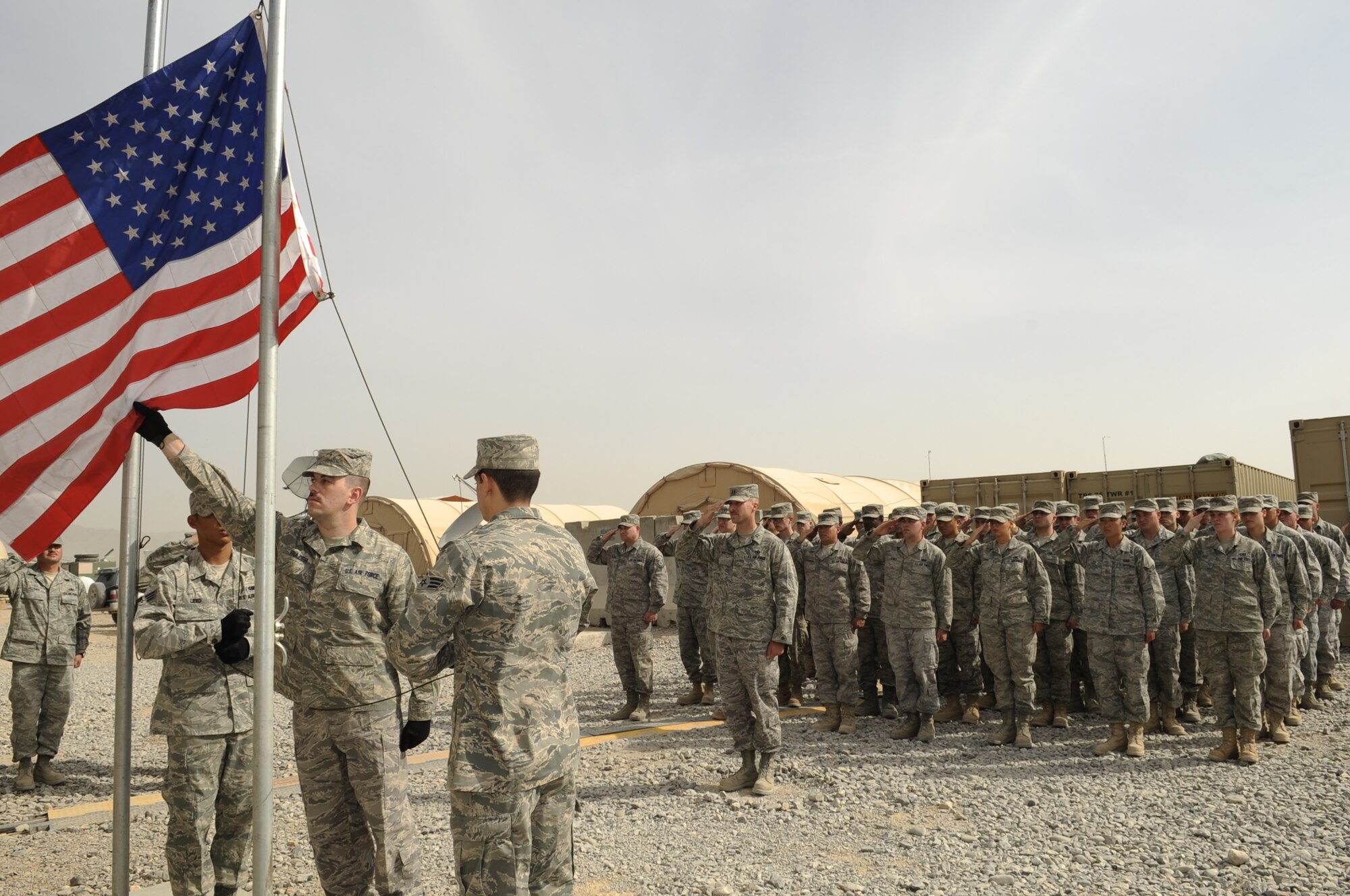 Members from the 73rd Expeditionary Air Control Squadron, Kandahar Airfield, render a salute while the National Anthem is played during a memorial ceremony for Airman 1st Class Antoine J. Holt.  Airman Holt served in Operation Iraqi Freedom at Balad Air Base, Iraq where he was fatally wounded on April 10, 2004 from a mortar attack that landed in his tent.  Many of the deployed members at the 73rd EACS are assigned to the 603rd ACS, Aviano Air Base, Italy, where Airman Holt was assigned prior to his deployment. Airman Holt was the only squadron member in the history of the unit to be killed in action while serving in a combat zone.  (U.S. Air Force photo by Senior Airman Nancy Hooks/Released)
