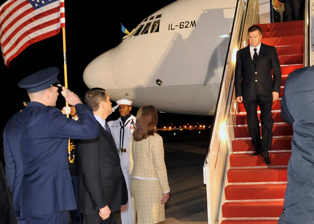 Viktor Yanukovych, President of Ukraine, is greeted by the Assistant Chief of Protocol for Diplomatic Affairs for the U.S. State Department, Gladys Boluda, and Col. Mark Allison, 316th Wing staff judge advocate, on the flight line at Joint Base Andrews, Md., April 11, 2010. The national delegate landed at Andrews on his way to the Nuclear Security Summit hosted by President Barack Obama in Washington, D.C., which is slated for Monday and Tuesday. The 316th Wing is leading operations to provide safe, effective and efficient arrival and departure services for the invited guests transiting Andrews. (U.S. Air Force photo by Staff Sgt. Renae Saylock)