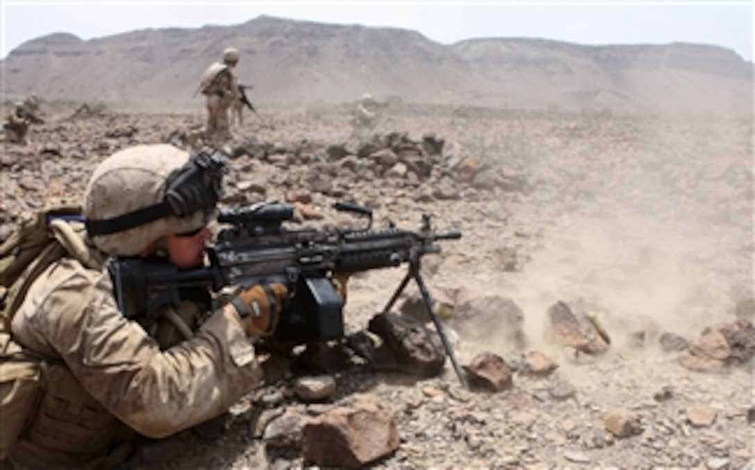 U.S. Marine Corps Lance Cpl. Tim Eastep, a rifleman with 1st Platoon, Alpha Company, Battalion Landing Team, 1st Battalion, 9th Marine Regiment, 24th Marine Expeditionary Unit, provides suppression fire with an M249 squad automatic weapon during a mechanized assault on a live-fire range in Djibouti on March 29, 2010.  The Marines are performing a series of sustainment and joint exercises with French military service members while in Djibouti.  The 24th Marine Expeditionary Unit serves as the theater reserve force for Central Command during its seven-month deployment aboard Nassau Amphibious Ready Group vessels.  