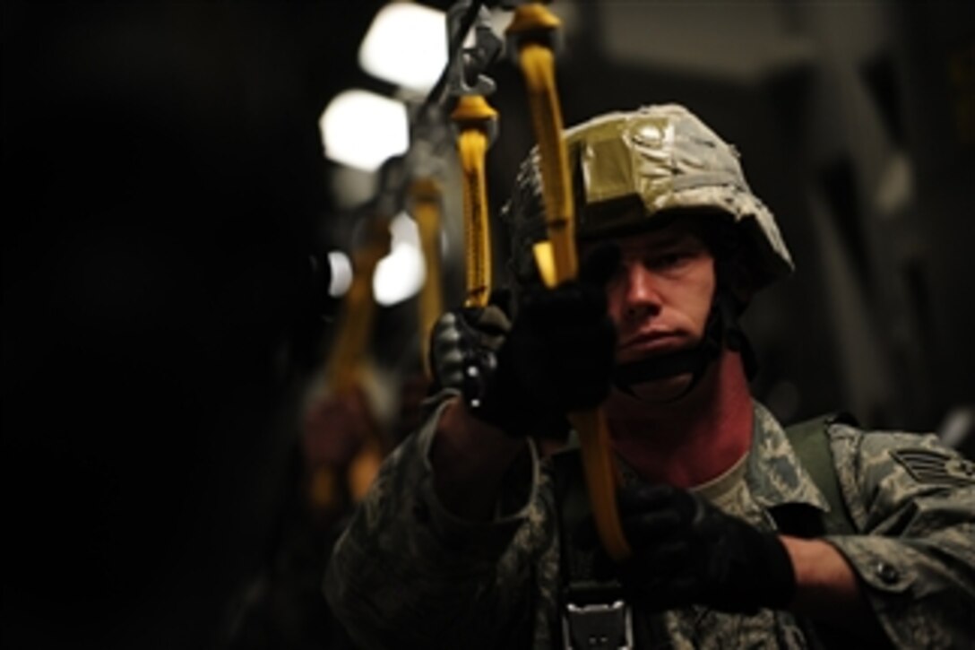 A U.S. Air Force airman assigned to the 823rd Security Forces Squadron, Moody Air Force Base, Ga., secures his static line before a personnel drop training mission at North Auxiliary Airfield in South Carolina on April 7, 2010.  The aircraft and its crew are assigned to the 15th Airlift Squadron, Joint Base Charleston, S.C.  