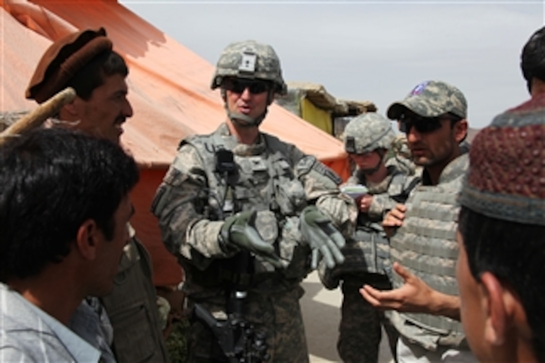 U.S. Army Col. James Johnson, the commander of the 173rd Airborne Brigade Combat Team, speaks with residents in the village of Powraq in the Pole-Elam district of the Logar province of Afghanistan on April 6, 2010.  Johnson is conducting a mission to assess conditions in the village.  