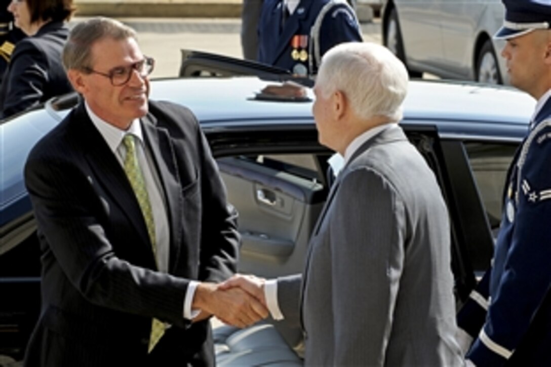 Australian Defense Minister John Faulkner, left, arrives at the Pentagon, April 12, 2010, where U.S. Defense Secretary Robert M. Gates welcomes him. The two defense leaders will hold bilateral security talks on a range of issues.  