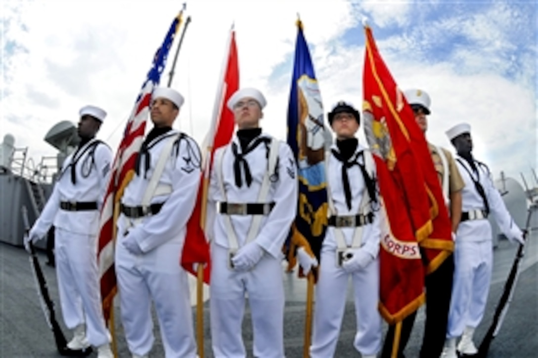 A U.S. Navy detail presents the colors aboard the amphibious command ship USS Blue Ridge as the ship arrives in Jakarta, Indonesia, April 11, 2010.