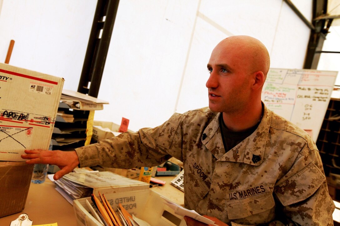 Sgt. Derek Spoor, deck non-commissioned officer at the postal warehouse with Headquarters and Service Company, 1st Marine Logistics Group (Forward) explains to a mail clerk the process of returning mail at Camp Leatherneck, Afghanistan, April 12. The postal Marines work day in and day out to make sure every letter and package is delivered to its intended recipient.
