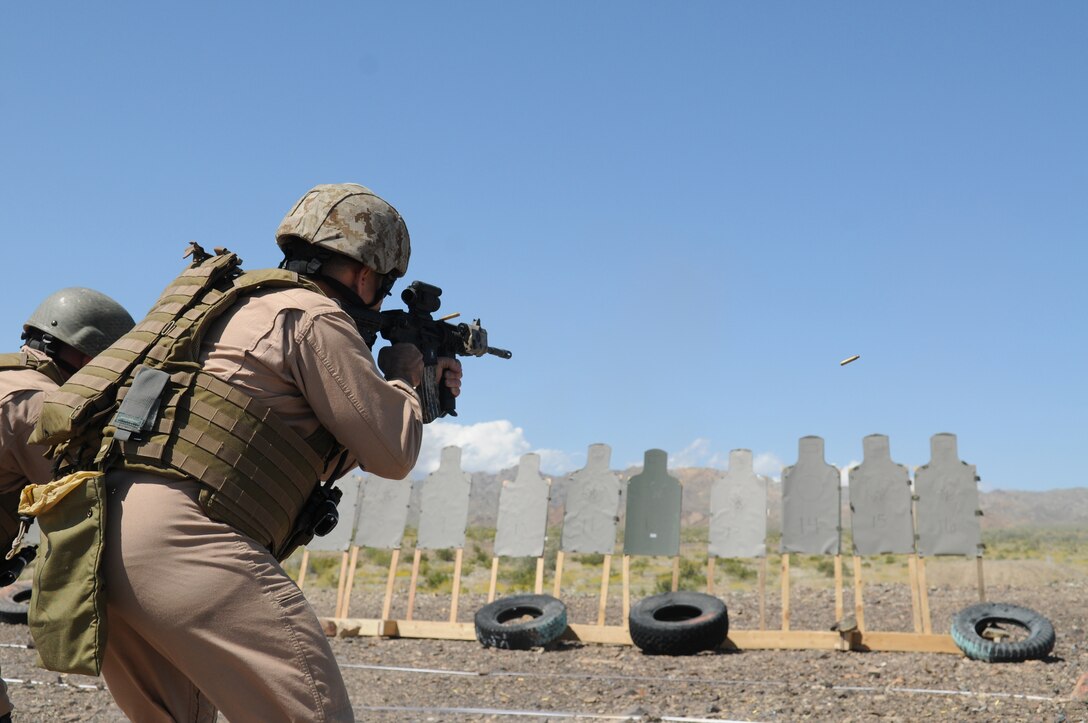 Warrant Officer Kent Crawley, Marine Wing Support Squadron 373 explosive ordnance disposal officer in charge, fires a hammer pair from his M-4 carbine at a target during close-quarter battle marksmanship training at Camp Billy Machen, Calif., April 12, 2010. MWSS-373’s EOD team is being trained in Yuma by MWSS-371’s EOD team for an upcoming deployment to Afghanistan. The training was conducted by Master Gunnery Sgt. Carl Holden, MWSS-371’s EOD staff noncommissioned officer in charge, who is a former Marine Special Operations Command close-quarter battle instructor. The training used both M-4s and M-9 pistols, with emphasis on transitioning from the rifle to the pistol in CQB situations. “When your rifle runs dry, you’ve got another loaded weapon with you. Use it!” said Holden.