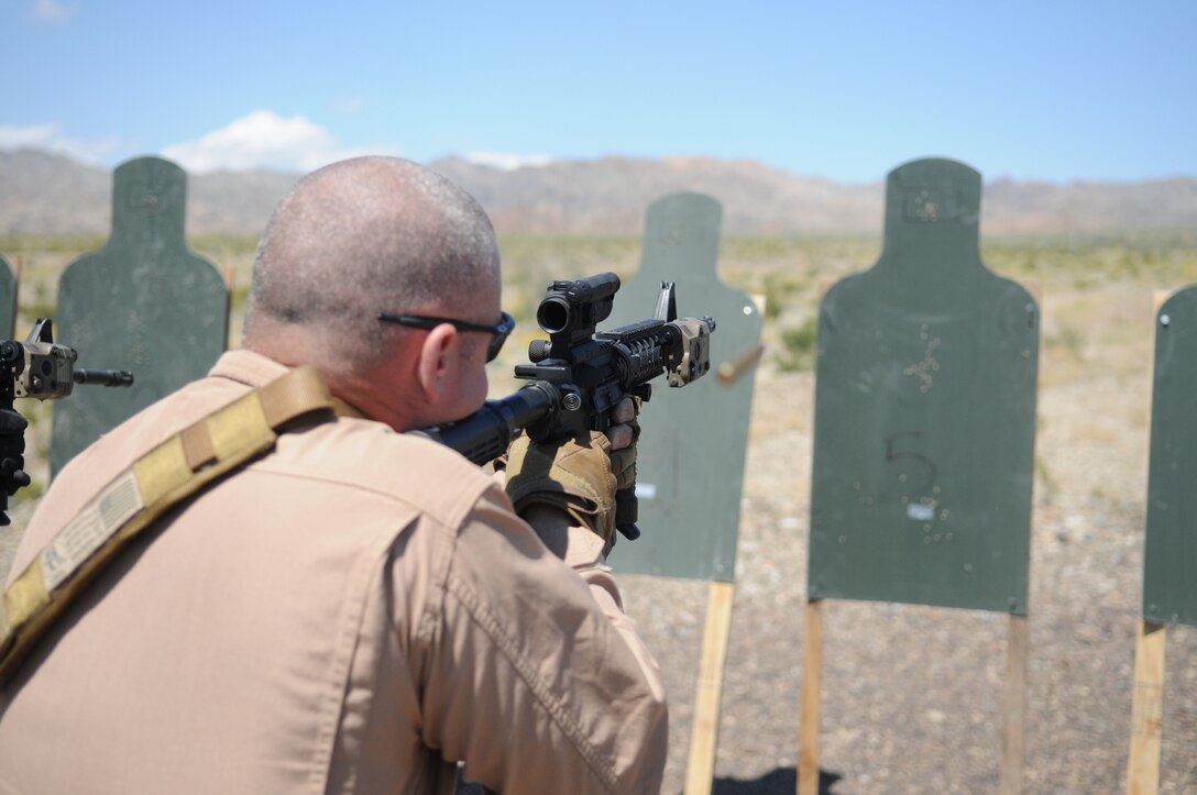 Gunnery Sgt. Nathaniel Crosby, Marine Wing Support Squadron 373 explosive ordnance disposal technician, fires his M-4 carbine at a target during close-quarter battle marksmanship training at Camp Billy Machen, Calif., April 12, 2010. MWSS-373’s EOD team is being trained in Yuma by MWSS-371’s EOD team for an upcoming deployment to Afghanistan. The training was conducted by Master Gunnery Sgt. Carl Holden, MWSS-371’s EOD staff noncommissioned officer in charge, who is a former Marine Special Operations Command close-quarter battle instructor. The training used both M-4s and M-9 pistols, with emphasis on transitioning from the rifle to the pistol in CQB situations. “When your rifle runs dry, you’ve got another loaded weapon with you. Use it!” said Holden.