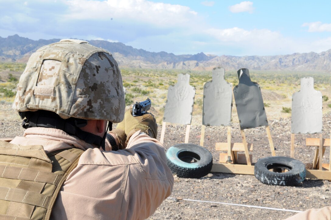 Gunnery Sgt. Nathaniel Cosby, Marine Wing Support Squadron 373 explosive ordnance disposal staff noncomissioned officer in charge, fires his M-9 pistol at a target during close-quarter battle marksmanship training at Camp Billy Machen, Calif., April 12, 2010. MWSS-373’s EOD team is being trained in Yuma by MWSS-371’s EOD team for an upcoming deployment to Afghanistan. The training was conducted by Master Gunnery Sgt. Carl Holden, MWSS-371’s EOD staff noncommissioned officer in charge, who is a former Marine Special Operations Command close-quarter battle instructor. The training used both M-4 carbines and M-9 pistols, with emphasis on transitioning from the rifle to the pistol in CQB situations. “When your rifle runs dry, you’ve got another loaded weapon with you. Use it!” said Holden.