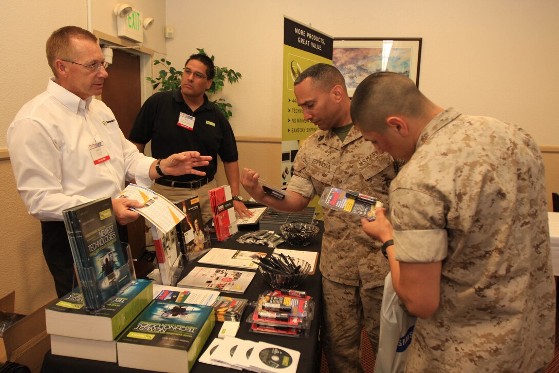 MARINE CORPS AIR GROUND COMBAT CENTER TWENTYNINE PALMS, Calif. - Combat Center Marines check out a company called Newark, which sells electronic components and test equipment, during a technology expo April 13 at the Combat Center's Officers' Club.