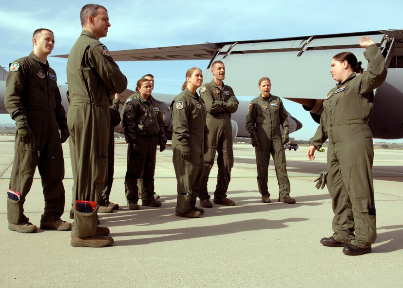 Technical Sgt. Monica Eastman from the 45th Aeromedical Evacuation Squadron, McDill AFB, Fla., instructs U.S. Air Force members on the exterior body of the KC-135 Stratotanker during the Dissimilar Aircraft Readiness Training exercise at March ARB, Calif. Dissimilar Aircraft Readiness Training, also known as DART, is a quarterly exercise for Air Force Reserve Command aeromedical evacuation squadrons. It provides hands-on training to flight nurses and aeromedical technicians on different aircraft than they have at their home bases.  (U.S. Air Force photo/Senior Airman Joseph Araiza)