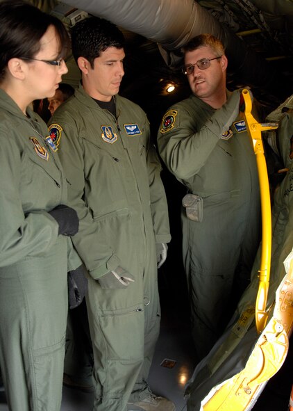 Senior Airman Krista Alldritt and Staff Sgt. Ryan Romo, both from the 446th Aeromedical Evacuation Squadron, Joint Base Lewis-McChord, Wash., listen to Master Sgt. Kelly Jelstrom, also from Lewis-McChord, explain and demonstrates how to close the crew entrance door of a U.S. Air Force KC-135 Stratotanker aircraft during the Dissimilar Aircraft Readiness Training exercise at March ARB, Calif.  Dissimilar Aircraft Readiness Training, also known as DART, is a quarterly exercise for Air Force Reserve Command aeromedical evacuation squadrons. It provides hands-on training to flight nurses and aeromedical technicians on different aircraft than they have at their home bases. (U.S. Air Force photo/Senior Airman Joseph Araiza)