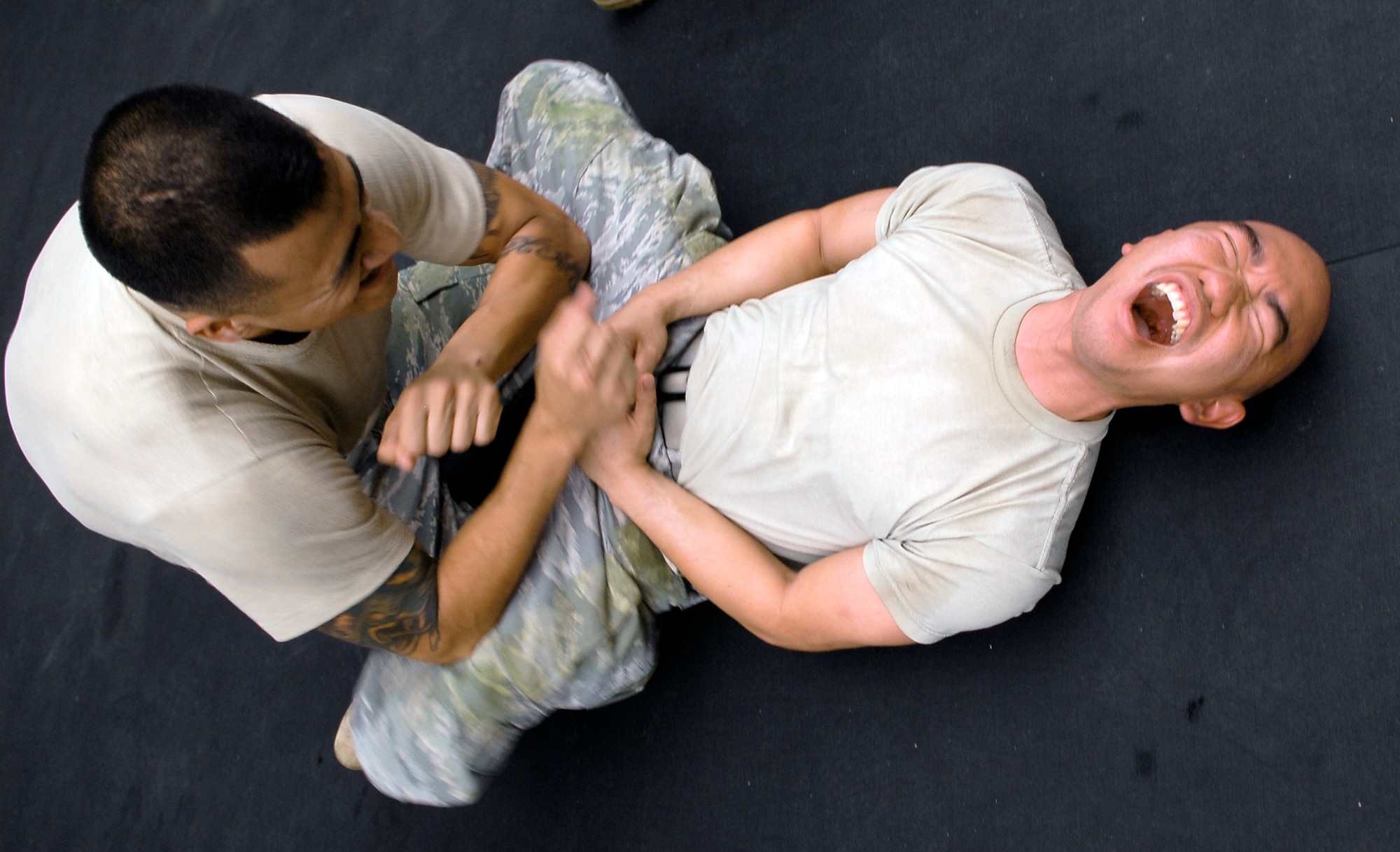 Staff Sgt. Abel Telles (left) elbows the inner thighs of Staff Sgt. Anthony Cubillo in an exercise called "body hardening" during a military combative training course April 5, 2010, at Luke Air Force Base, Ariz. Sergeant Telles is a 56th Logistics Readiness Squadron fuels specialist. Sergeant Cubillo is a 56th Maintenance Operations Squadron weapons systems coordinator. (U.S. Air Force photo/Airman 1st Class Ronifel Yasay)