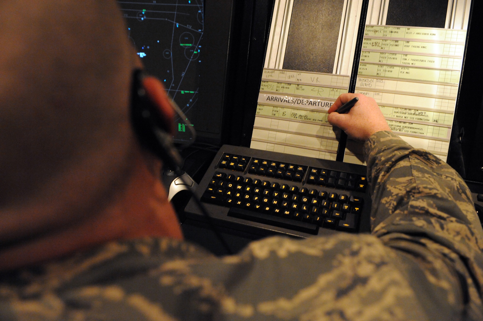 WHITEMAN AIR FORCE BASE, Mo. - Senior Airman Bobby Bielby, 509th Operations Support Squadron air traffic controller, writes on a flight progress strip for the approach controller. The flight progress strips have all the aircraft's important information.(U.S. Air Force photo/Staff Sgt. Jason Huddleston)

