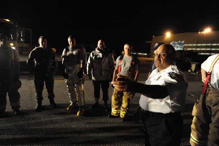 Roger Schwartz gives a debrief of the C-17 egress training April 12, 2010, at Joint Base Charleston, S.C. Firefighters practice C-17 egress training to ensure they know how to respond to aircraft mishaps. Mr. Schwartz is assistant fire chief for A shift operations with the 628th Civil Engineer Squadron. (U.S. Air Force photo by James M. Bowman/released)