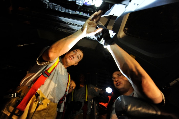 Staff Sgt. Mathew Raimo and Staff Sgt. William Jenkins go over aircraft shut down procedures during C-17 egress training April 12, 2010, at Joint Base Charleston, S.C. Firefighters practice C-17 egress training to ensure they know how to respond to aircraft mishaps. Sergeant Raimo and Jenkins are crew chiefs with the 628th Civil Engineer Squadron. (U.S. Air Force photo by James M. Bowman/released)