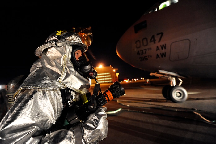 Tech Sgt. Todd Barnett maintains the back up water line for a rapid intervention team during C-17 egress training April 12, 2010, at Joint Base Charleston, S.C. Sergeant Barnett's primary responsibility is to help the attack team if trouble should arise inside the C-17. Sergeant Barnett is a crew chief with the 628th Civil Engineer Squadron. (U.S. Air Force photo by James M. Bowman/released)