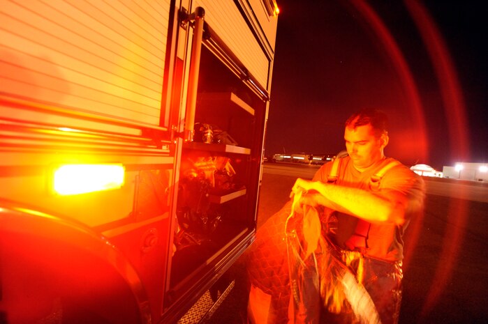 Staff Sgt. Justin Martin takes off his proximity gear after C-17 egress training was completed April 12, 2010, at Joint Base Charleston, S.C. His responsibility is to shut down the aircraft and ensure crew members depart the aircraft safely. Sergeant Martin is a rescue team member with the 628th Civil Engineer Squadron. (U.S. Air Force photo by James M. Bowman/released)