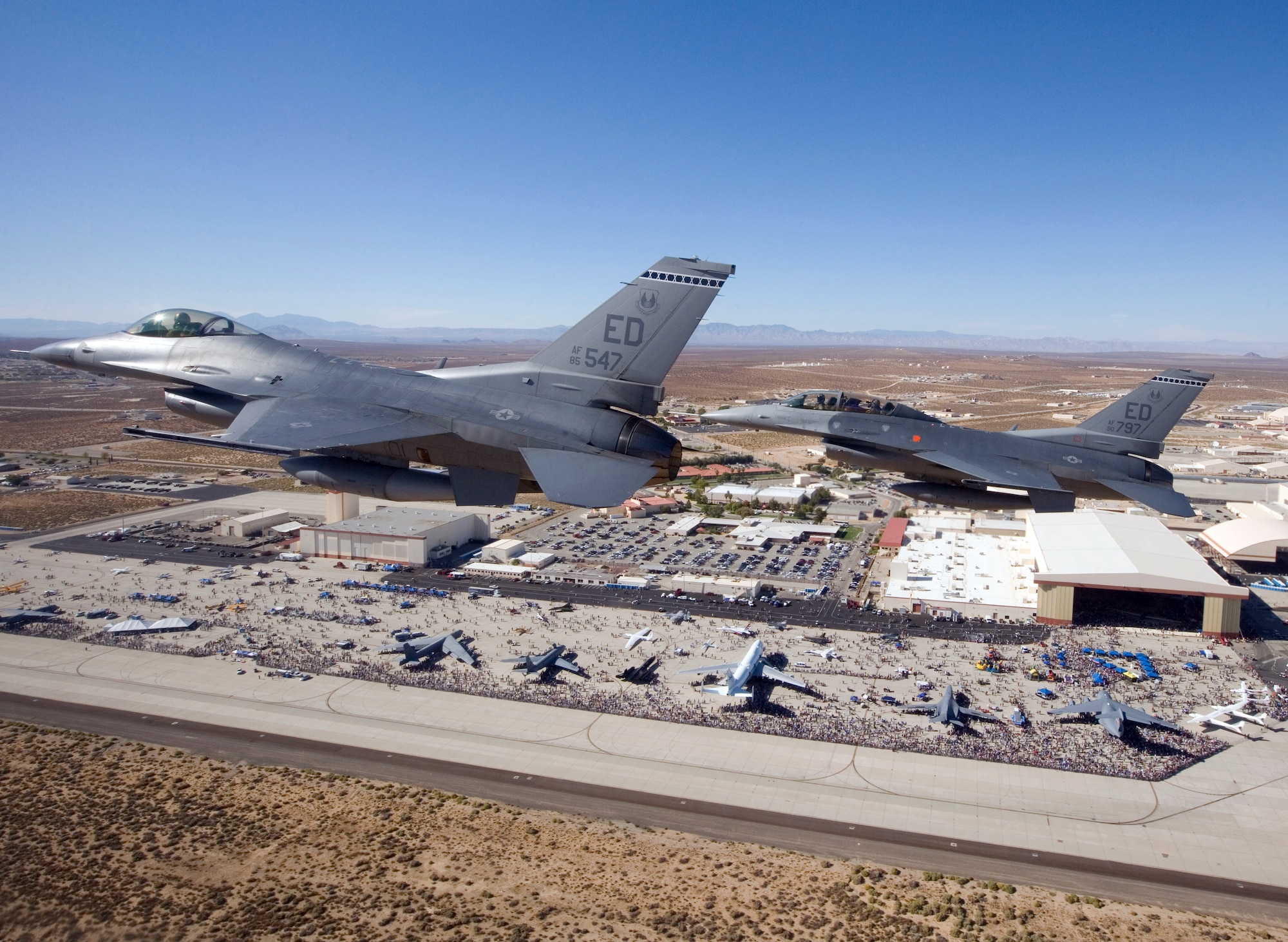 Two F-16 Fighting Falcons fly over Edwards AFB during the October 17, 2009 air show.  95th Air Base Wing Public Affairs received the 2009 Air Force Integrated Communication Excellence Award for branding and marketing the air show and open house that drew more than 225,000 attendees. Air Force photo by Chad Bellay.