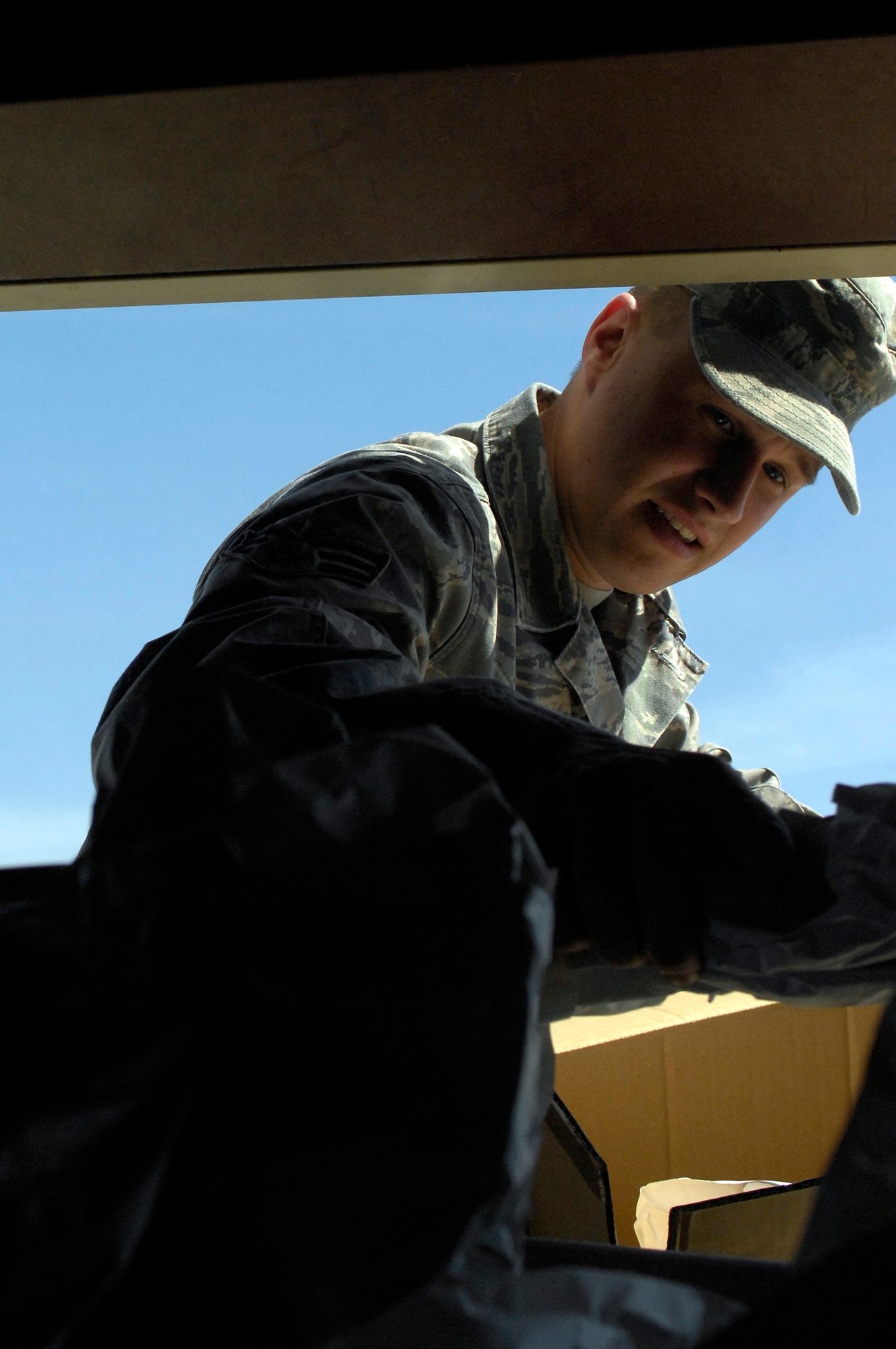 Senior Airman Jason Schuler, 509th Maintenance Squadron, drops packing paper into a  recycling bin at the Whiteman Recycling Center April 12, 2010. The recycling center has several bins in place to collect recyclable material 24 hours a day. (U.S. Air Force Photo/Staff Sgt. Jason Barebo)