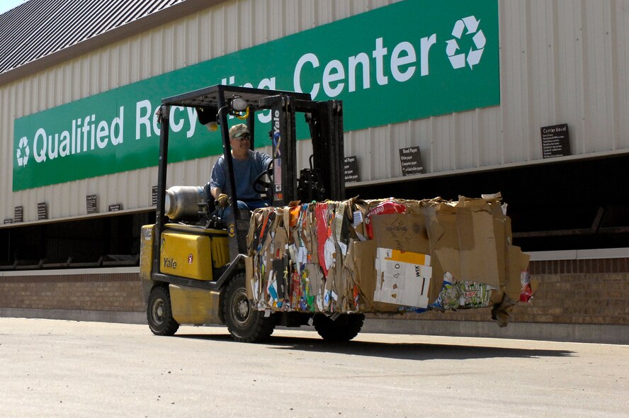 Mr. Mark Davis, Whiteman Recycling Center material examiner, transfers a bail of cardboard April 12, 2010, from the processing building to their warehouse for storage. Recycling center personnel store bailed recyclable material until the buying price is high and it is then sold to make the most revenue possible. (U.S. Air Force photo/Staff Sgt. Jason Barebo) 