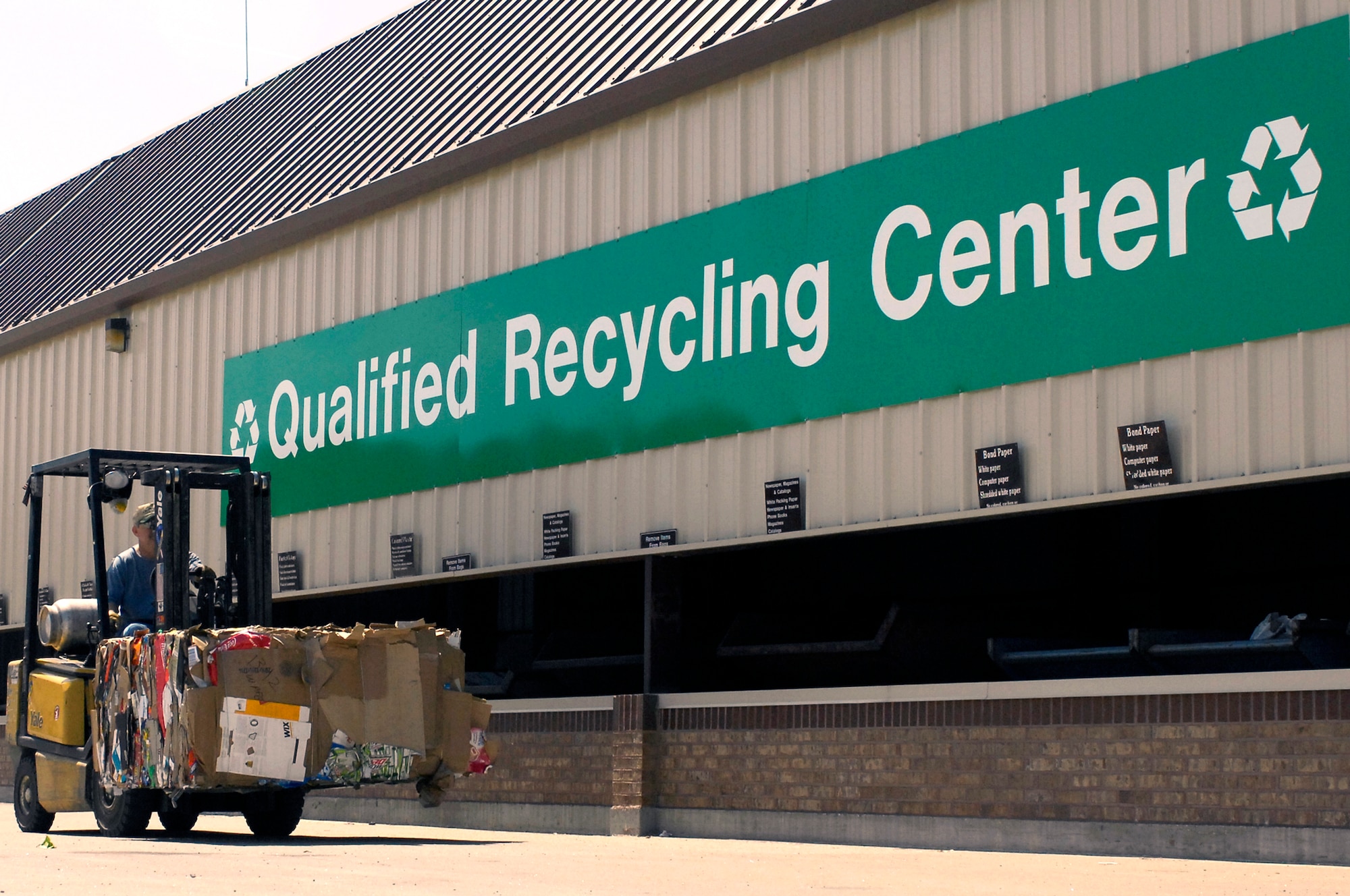 Mr. Mark Davis, Whiteman Recycling Center material examiner, transfers a bail of cardboard April 12, 2010, from the processing building to their warehouse for storage. Recycling center personnel store bailed recyclable material until the buying price is high and it is then sold to make the most revenue possible. (U.S. Air Force photo/Staff Sgt. Jason Barebo) 