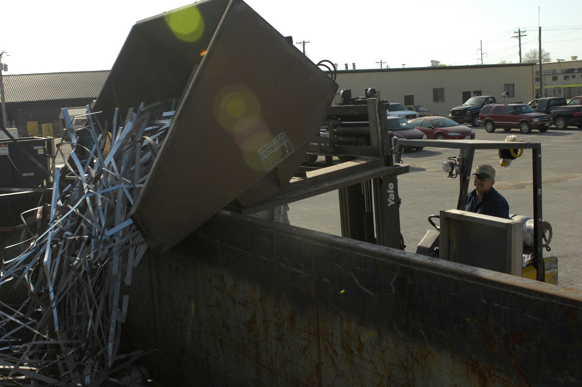 Mr. Mark Davis, Whiteman Recycling Center material examiner, transfers recyclable scrap metal to a bin containing more scrap metal April 12, 2010. Revenue from the recycling center has funded many base projects including the rubberized coating on the running track and the batting cages. (U.S. Air Force photo/Staff Sgt. Jason Barebo)
