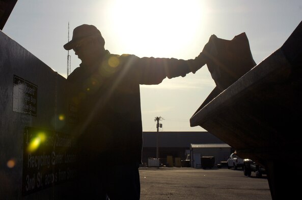 Mr. Mark Davis, Whiteman Recycling Center material examiner, sorts through a cardboard recycling bin early morning April 12, 2010 to ensure no other recyclable or non-recyclable materials are mixed in. The recycling center provides a drop-off point for recyclable materials at the commissary parking lot. (U.S. Air Force photo/Staff Sgt. Jason Barebo)