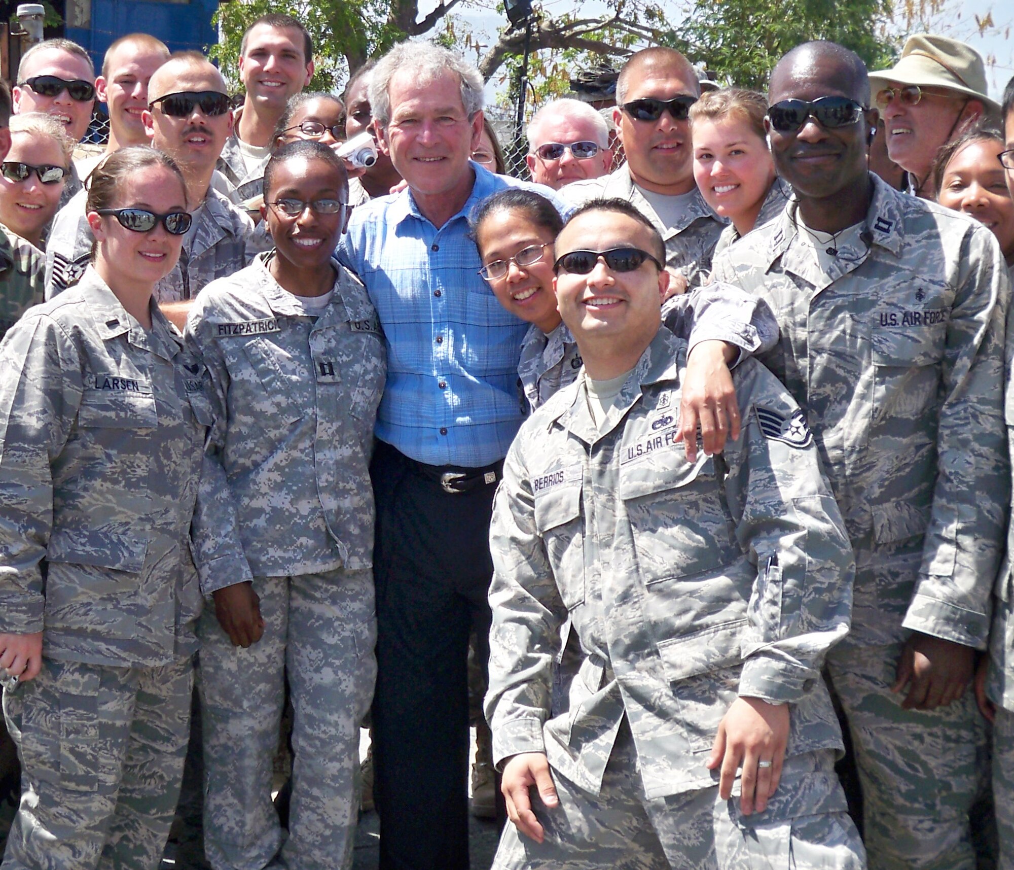 934th Aeromedical Evacuation Squadron members Capt. John Wimbley,(right) and 1st Lt. Jennifer Larsen, ( left) pose with former President George Bush in Haiti.  The two make up an Aeromedical Evacuation Liason Team to help validate and coordinate patient movement for contractors and military personnel evacuated out of Haiti. (Courtesy Photo)
