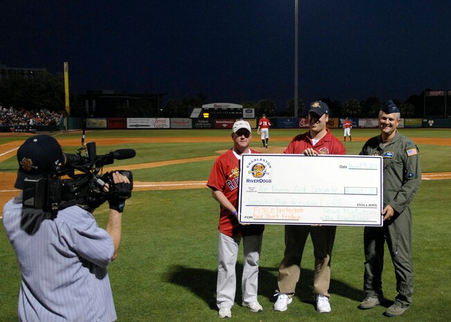 Col. Mike Speer, right, accepts a check for $2,500 from Jim Pfander and Tommy Pruitt, left, at a Charleston RiverDogs game April 9, 2010, at Joseph P. Riley Jr. Park in Charleston, S.C. The check was made out to the Air Force Aid Society from Force Protection, a manufacturer of blast- and ballistic-protected armored vehicles and other survivability products, and the Charleston RiverDogs baseball team in support of the annual Air Force Assistance Fund campaign. Colonel Speer is the 315th Airlift Wing vice commander; Mr. Pruitt is the senior director of communications for Force Protection; and Mr. Pfander is the assistant general manager for the Charleston RiverDogs. (U.S. Air Force photo/Senior Airman Timothy Taylor)