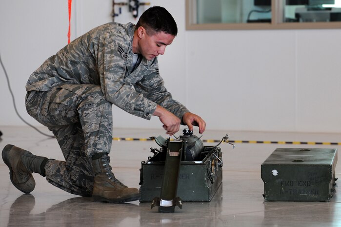CREECH AIR FORCE BASE, Nev. -- Senior Airman Terry Blue, weapons loader assigned to 432d Aircraft Maintenance squadron, inspects an inert AGM-114 Hellfire II air-to-ground missile April 12, 2010, during the 432d AMXS load crew of the quarter competition. (U.S. Air Force Photo by Airman 1st Class Brett Clashman)
