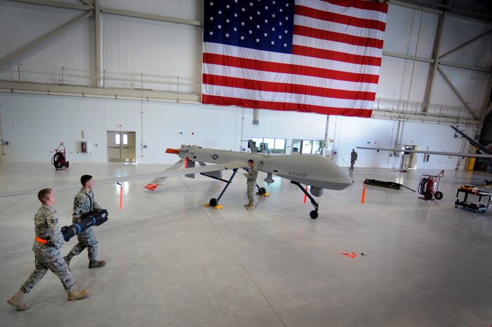CREECH AIR FORCE BASE, Nev. --  Senior Airman Terry Blue and Staff Sgt. William Bovee prepare to load an inert AGM-114 Hellfire II air-to-ground missile during the 432d Aircraft Maintenance Squadron load crew of the quarter competition April 12, 2010. Airman Blue and Sergeant Bovee are Predator weapons loaders assigned to the 432d AMXS. (U.S. Air Force photo by Tech. Sgt. Michael R. Holzworth)
