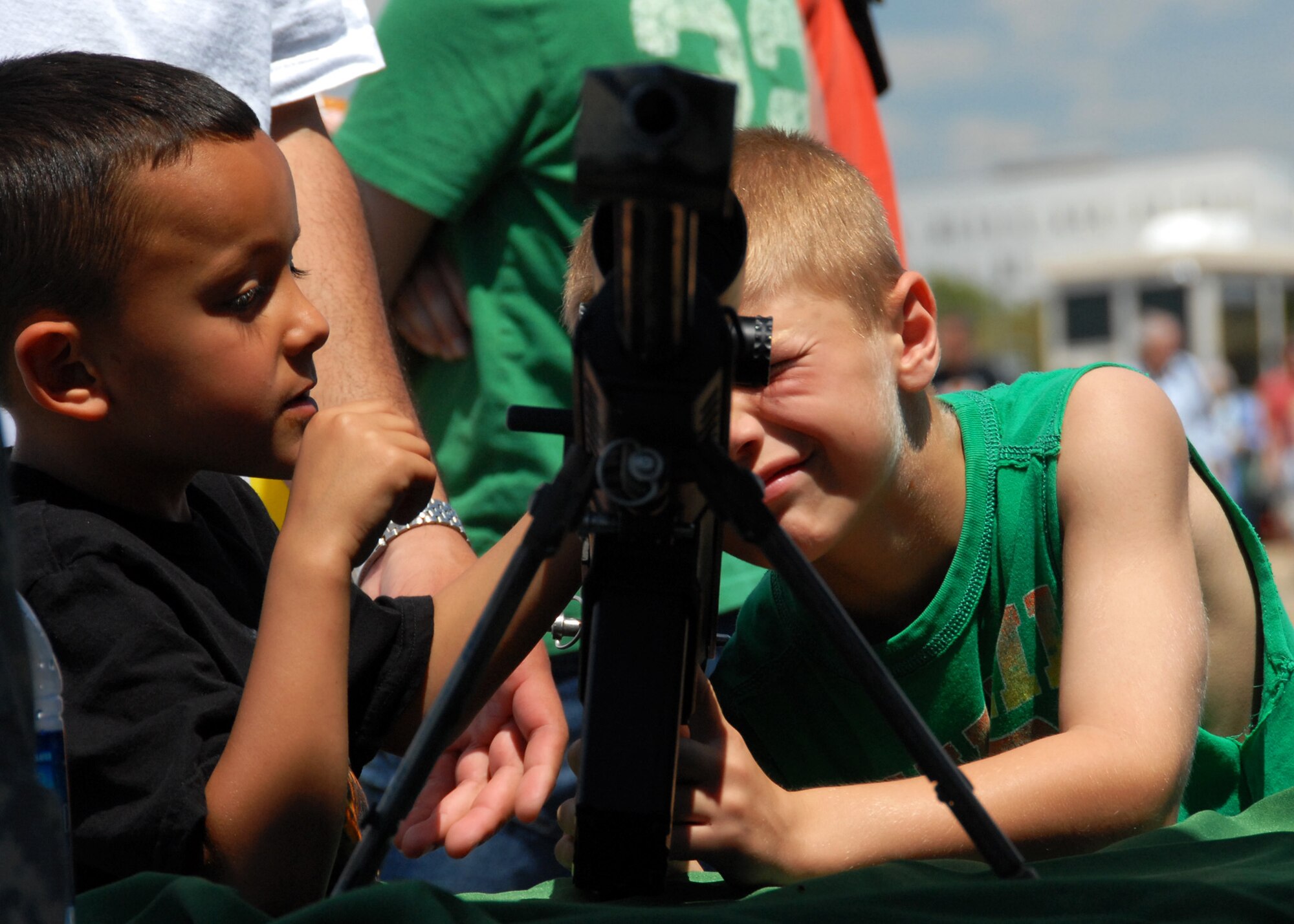 Kids take aim with the the sniper rifle at the weapons display April 11 at the Eglin 75th Anniversary Air Show. More than 125,000 were in attendance for the show April 10-11, enjoying a variety of aerial performances and static displays. This was Eglin’s first open house since 2007 and was timed to coincide with the 75th anniversary of the installation. The Thunderbirds, Army Black Daggers, an F-22A Raptor demo and "Tora, Tora, Tora" were some of the highlights of the event. (U.S. Air Force photo/Samuel King Jr.) 