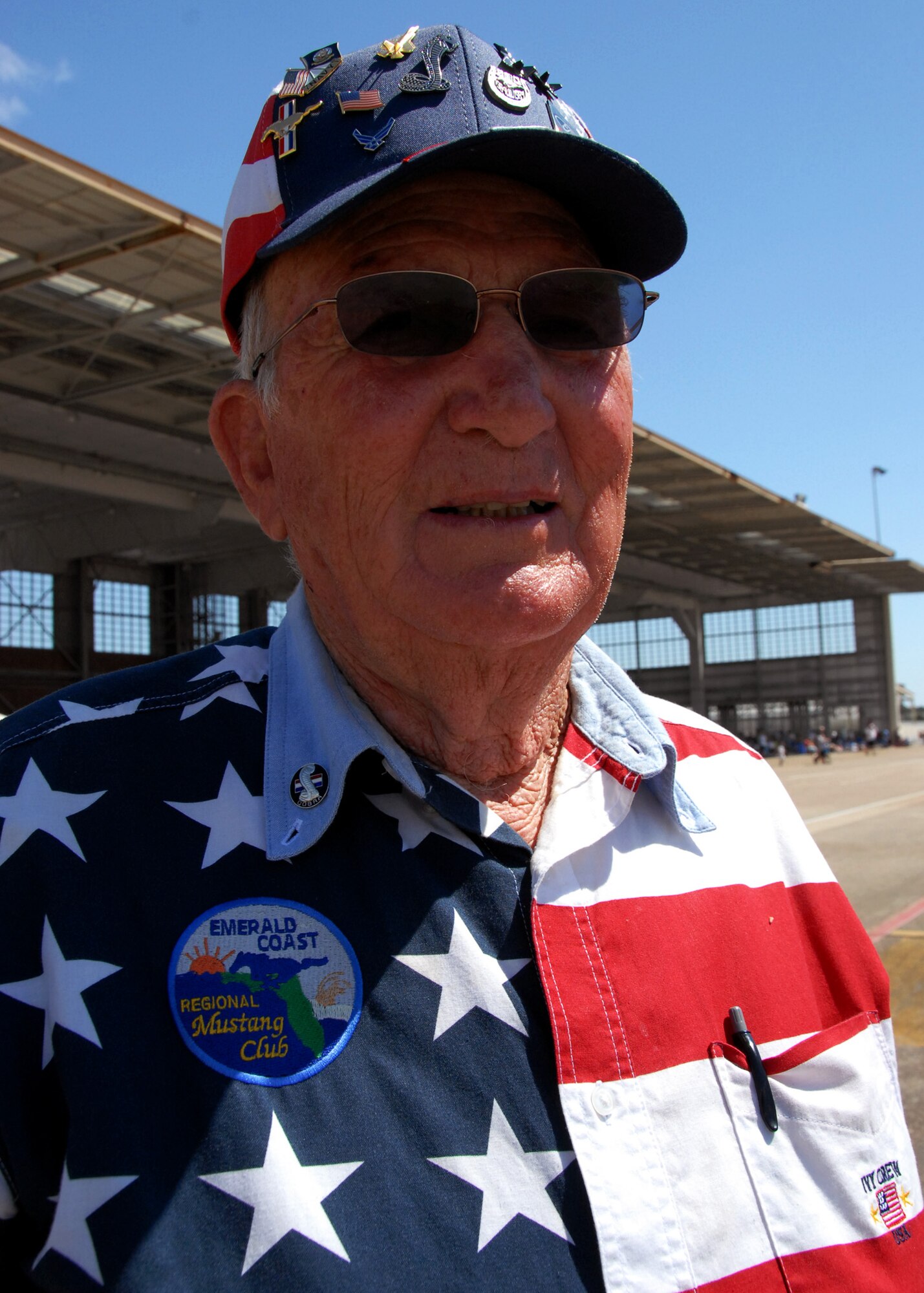 A patriotic member of the Emerald Coast Mustang Club surveys the events  at the Eglin 75th Anniversary Air Show April 11. More than 125,000 were in attendance for the show April 10-11, enjoying a variety of aerial performances and static displays. This was Eglin’s first open house since 2007 and was timed to coincide with the 75th anniversary of the installation. The Thunderbirds, Army Black Daggers, an F-22A Raptor demo and "Tora, Tora, Tora" were some of the highlights of the event. (U.S. Air Force photo/Samuel King Jr.) 