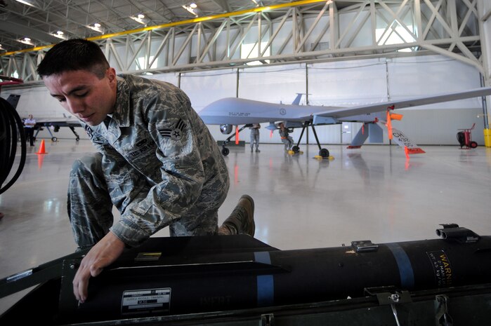 CREECH AIR FORCE BASE, Nev. --  Senior Airman Terry Blue, inspects an inert AGM-114 Hellfire II air-to-ground missile during the 432d Aircraft Maintenance Squadron load crew of the quarter competition here recently.  Senior Airman Blue is a Predator weapons loader assigned to the 432d AMXS.  (U.S. Air Force photo by Tech. Sgt. Michael R. Holzworth)
