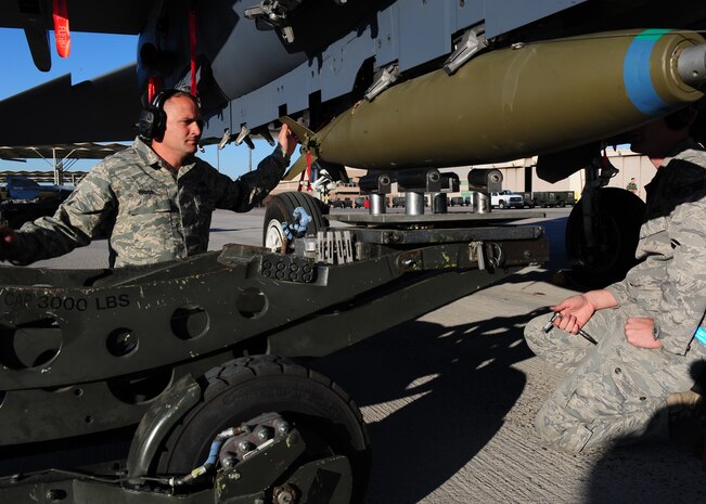 NELLIS AIR FORCE BASE, Nev. --  Staff Sgt. Sean Riggs and Senior Airman Robert Kaiser, load crew members from the 757th Aircraft Maintenance Squadron  load a bomb onto an F-15 Strike Eagle during a  load crew competition April 9, 2010.   (U.S. Air Force Photo by Staff Sgt. William P. Coleman)
