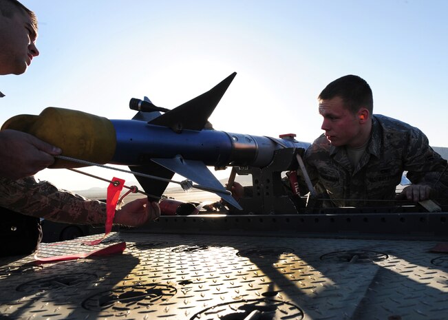 NELLIS AIR FORCE BASE, Nev. -- Staff Sgt. John Moyle and Airman 1st Class Nicholas Cunningham, 57th Aircraft Maintenance Squadron, Viper load crew members, prepare an AIM-9 sidewinder missile for loading during a load crew competition, April 9, 2010.  Airman Cunningham and SSgt Moyle along with Senior Airman Michele Atencio, won awards for best tool box and sharpest uniform.  (U.S. Air Force Photo by Staff Sgt. William P. Coleman)
