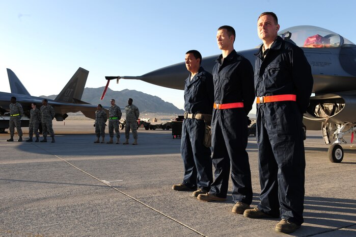 NELLIS AIR FORCE BASE, Nev. -- Airmen from the 57th Maintenance Group stand ready next to their jets as they wait for the load competition to begin, April 9, 2010.     (U.S. Air Force Photo by Staff Sgt. William P. Coleman)
