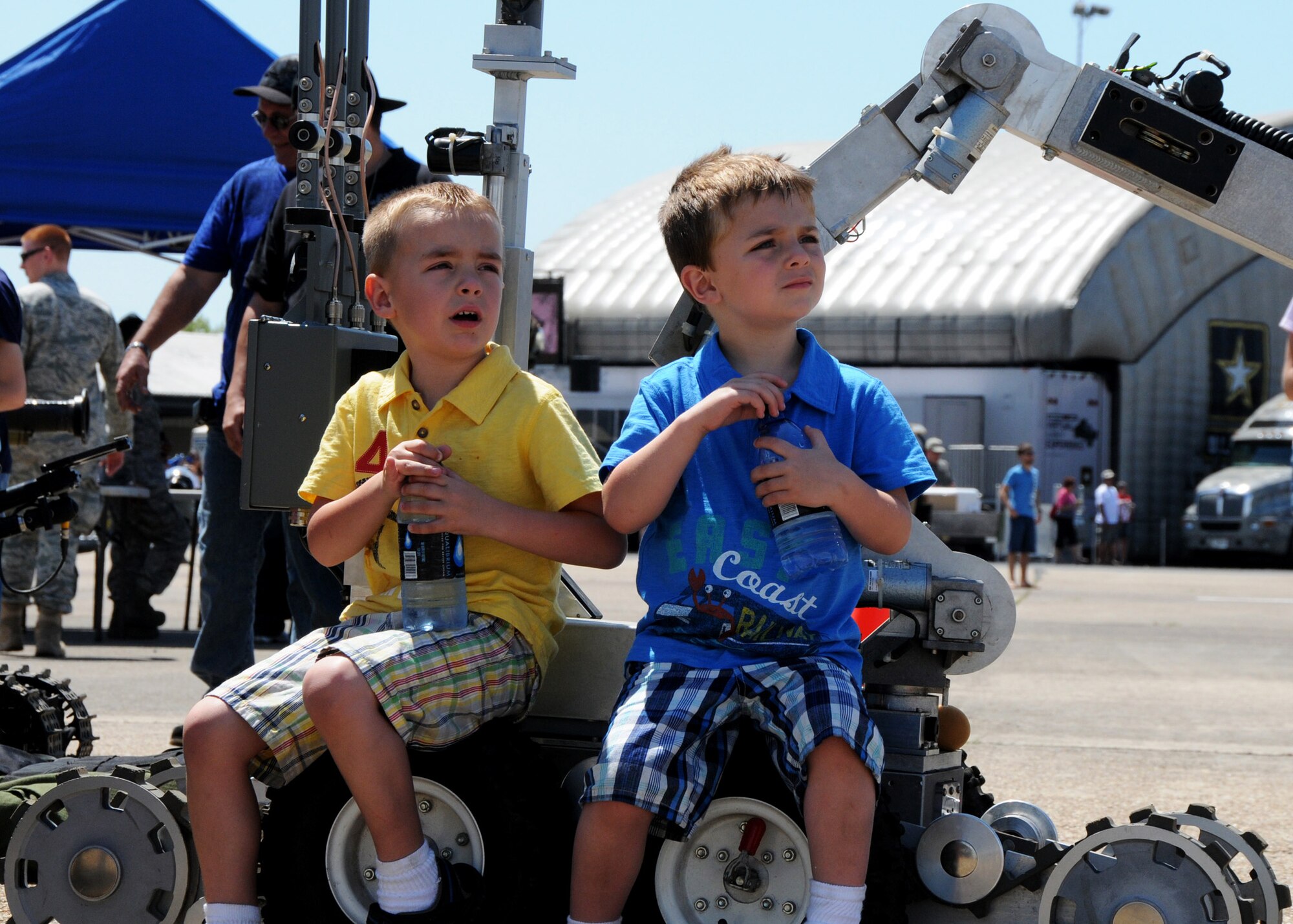 Hunter and Noble Parke take a seat on the Explosive Ordnance Detection robot to watch the flying acts April 11 at the Eglin 75th Anniversary Air Show. More than 125,000 were in attendance for the show April 10-11, enjoying a variety of aerial performances and static displays. This was Eglin’s first open house since 2007 and was timed to coincide with the 75th anniversary of the installation. The Thunderbirds, Army Black Daggers, an F-22A Raptor demo and "Tora, Tora, Tora" were some of the highlights of the event. (U.S. Air Force photo/Samuel King Jr.) 