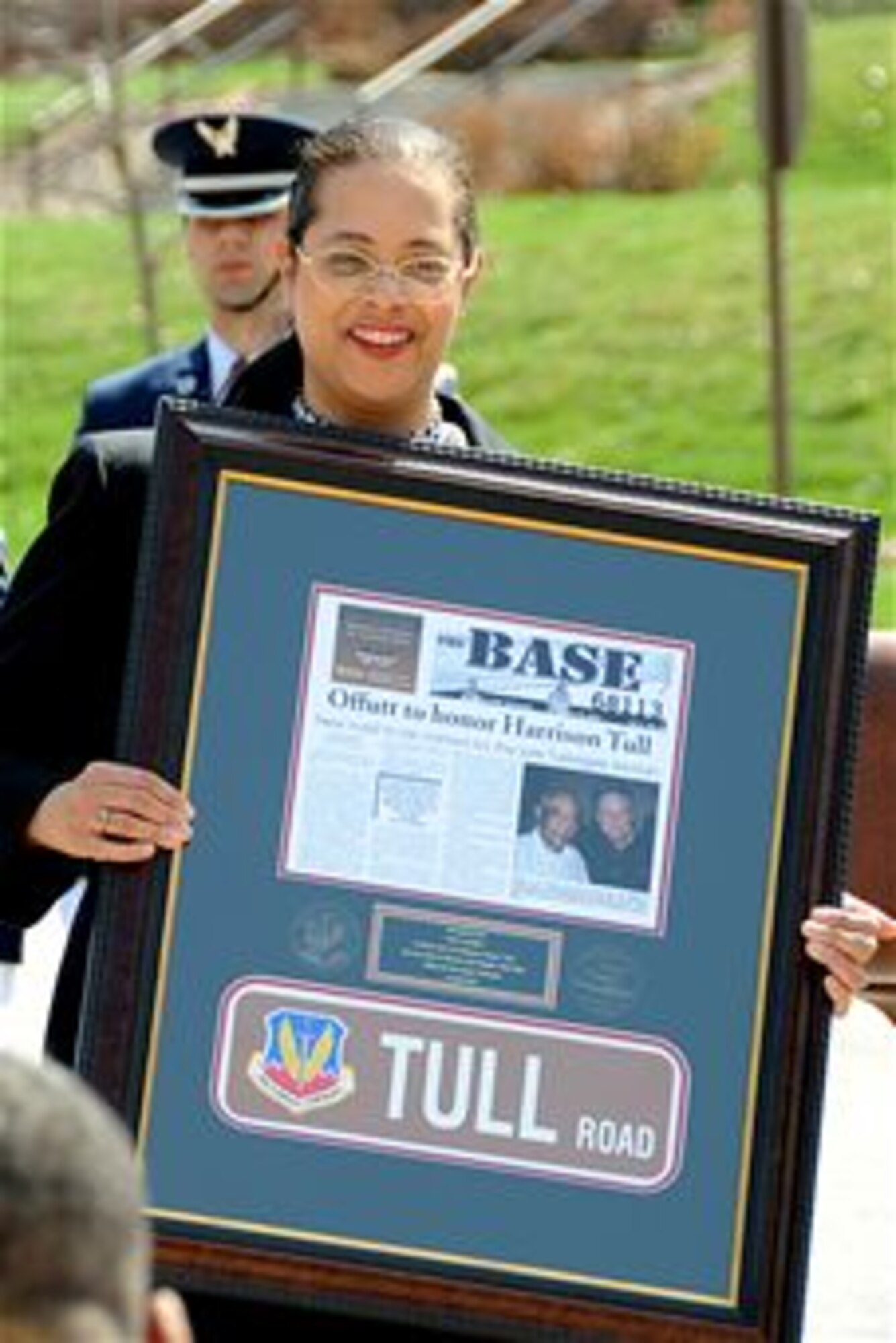 Dr. Janet Tull, the daughter of the late Lt. Col. Harrison "Harry" Tull, holds a plaque commemorating the dedication of Tull Road April 6, 2010, on Offutt Air Force Base, Neb.  Colonel Tull, who recently passed away, was a Tuskegee Airman during World War II and a former officer in the 55th Wing at Offutt AFB.  He served more than 27 years in the Air Force, including combat tours in the Korean and Vietnam Wars. (U.S. Air Force photo/Kendra Williams)