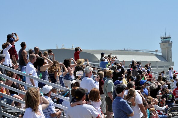 Fans in the stands turn and watch as the Thunderbirds roar by April 11 for the Eglin 75th Anniversary Air Show. More than 125,000 were in attendance for the show April 10-11, enjoying a variety of aerial performances and static displays. This was Eglin’s first open house since 2007 and was timed to coincide with the 75th anniversary of the installation. The Thunderbirds, Army Black Daggers, an F-22A Raptor demo and "Tora, Tora, Tora" were some of the highlights of the event. (U.S. Air Force photo/Airman 1st Class Anthony Jennings.) 