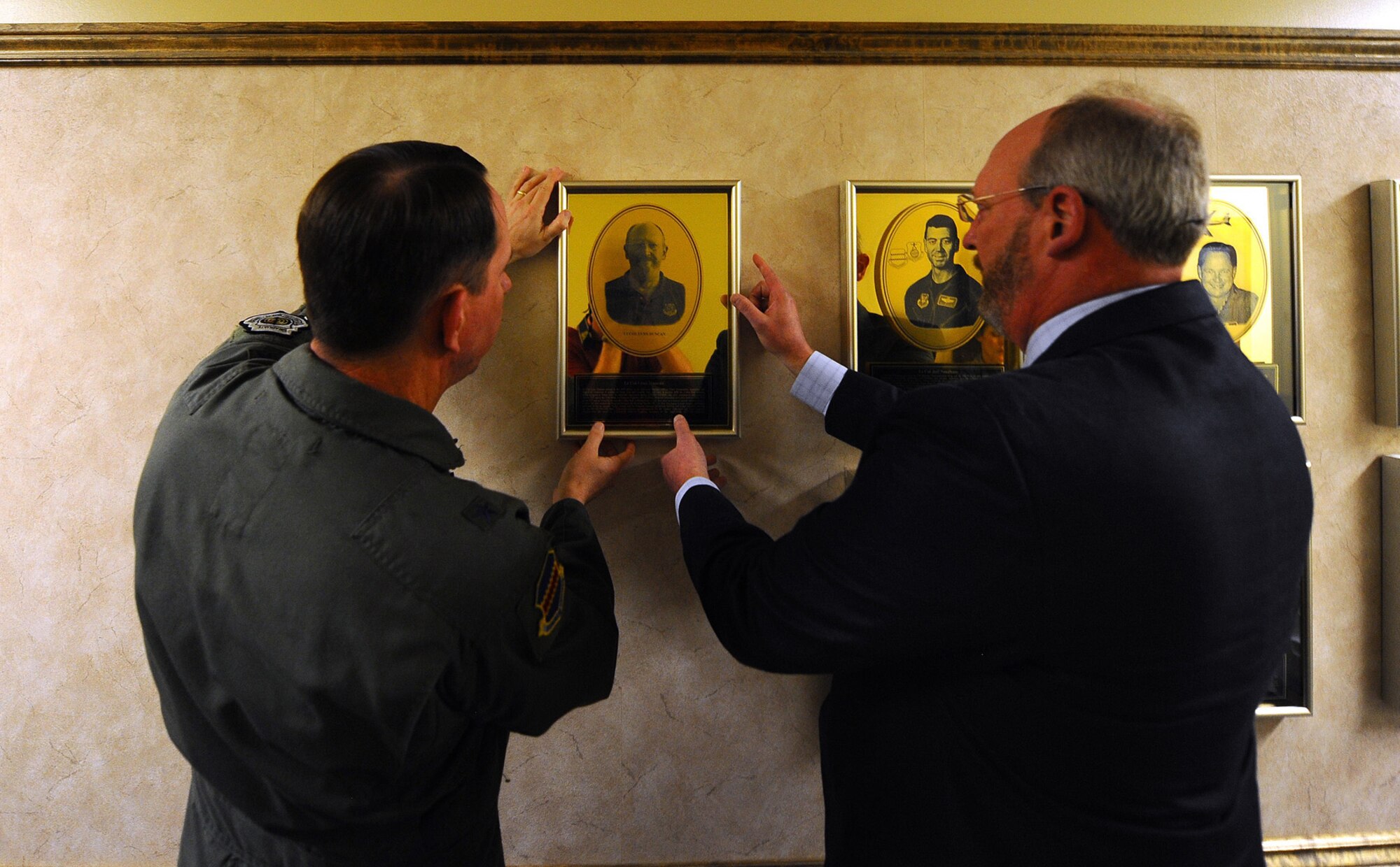 OFFUTT AIR FORCE BASE, Neb. -- Brig. Gen. John N.T. Shanahan, 55th Wing commander and retired Lt. Col. Howard L. (Lynn) Duncan, hang Colonel Duncan's plaque on the 55th Wing Hall of Fame inside the wing headquarters building here April 9. Colonel Duncan was awarded for serving the Fightin' Fifty-Fifth during his career, as well as his continued contributions following. U.S. Air Force photo by Josh Plueger
