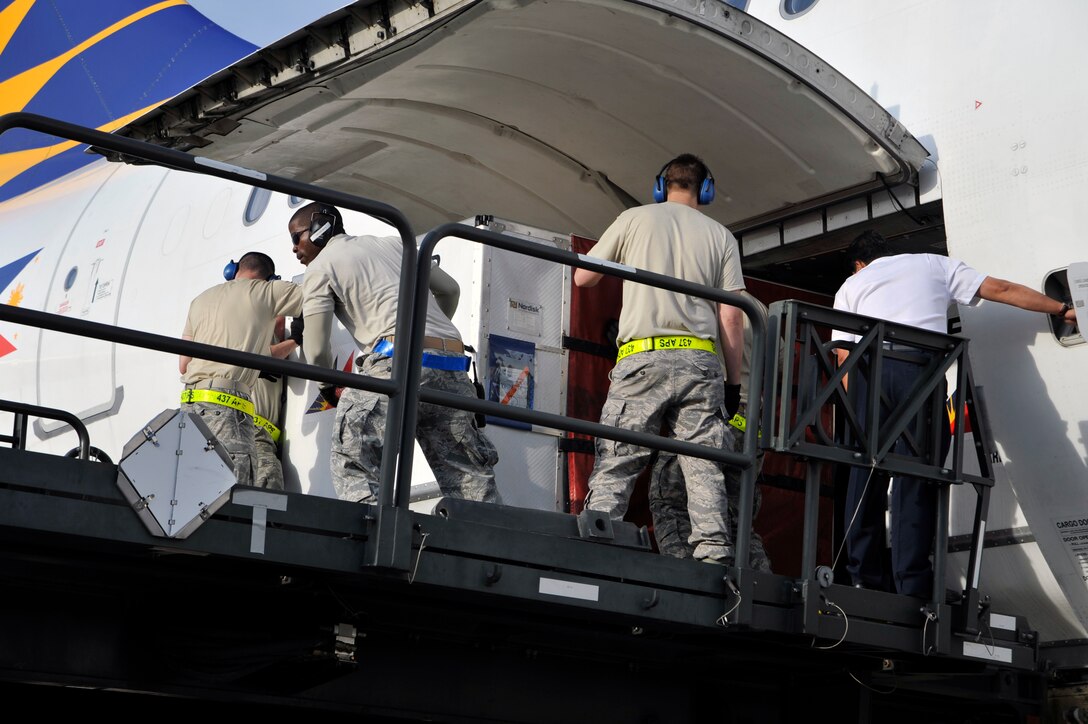 Airmen from the 89th Aerial Port Squadron and the 437th Aerial Port Squadron out of Charleston AFB, S.C., offload baggage from the Filipino President Gloria Macapagal-Arroyo's plane, April 12, 2010, at Joint Base Andrews, Md. Airmen from aerial port squadrons throughout the Air Force deployed to Joint base Andrews to support the Nuclear Security Summit hosted by President Barack Obama in Washington, D.C. The 316th Wing is leading operations to provide safe, effective, and efficient arrival and departure services for the invited guests transiting Andrews. (U.S. Air Force photo by Airman 1st Class Perry Aston) (Released)