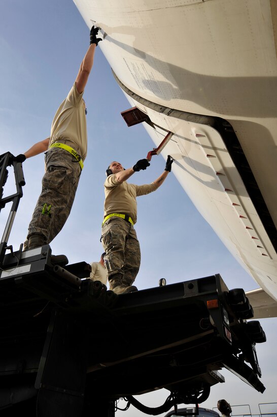 Airmen from 437th Aerial Port Squadron out of Charleston AFB, S.C. prepare to offload baggage from the Filipino President Gloria Macapagal-Arroyo's plane, April 12, 2010, at Joint Base Andrews, Md., in support of the Nuclear Security Summit hosted by President Barack Obama in Washington, D.C., this Monday and Tuesday. The 316th Wing is leading operations to provide safe, effective, and efficient arrival and departure services for the invited guests transiting Andrews. (U.S. Air Force photo by Airman 1st Class Perry Aston) (Released)